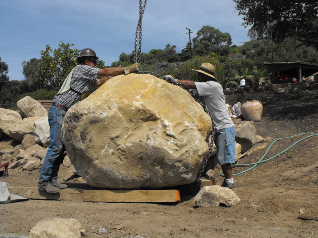 Preparing a Santa Barbara sandstone boulder for placement.